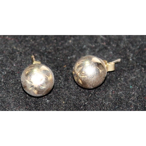 299 - A pair of 9ct gold ball earrings. 0.6g