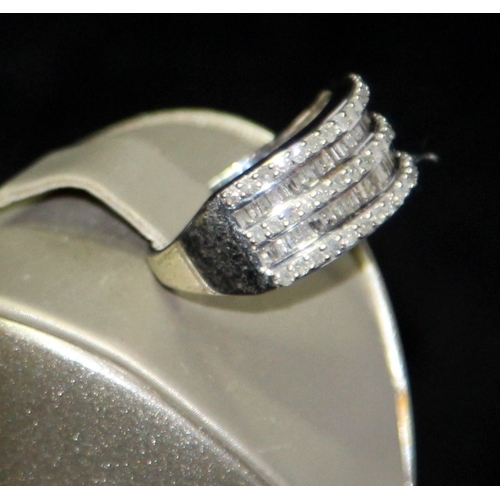 283 - 9ct white gold ring featuring round cut and baguette diamonds size P 1/2. 4.2g