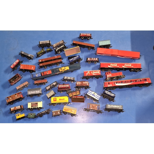 97 - A collection of mostly OO Gauge wagons and rolling stock to include Coca Cola.