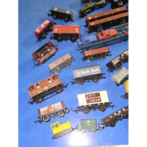 97 - A collection of mostly OO Gauge wagons and rolling stock to include Coca Cola.