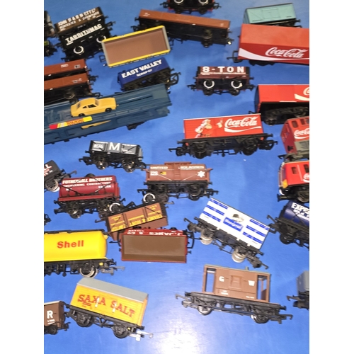 97 - A collection of mostly OO Gauge wagons and rolling stock to include Coca Cola.