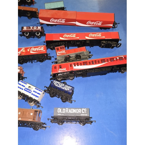 97 - A collection of mostly OO Gauge wagons and rolling stock to include Coca Cola.