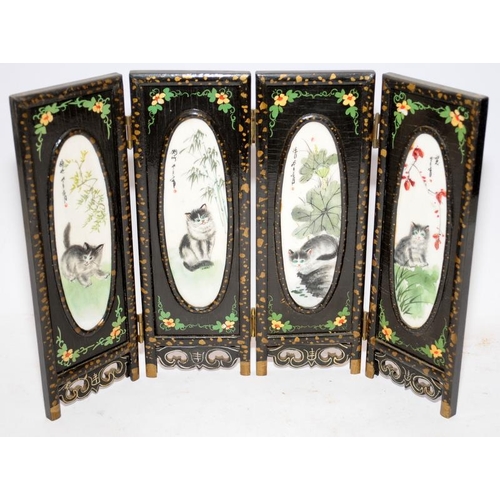 76 - Miniature Oriental wooden hinged screen of four panels each featuring a hand painted porcelain oval.... 