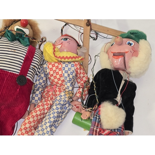 A collection of four vintage string puppets.