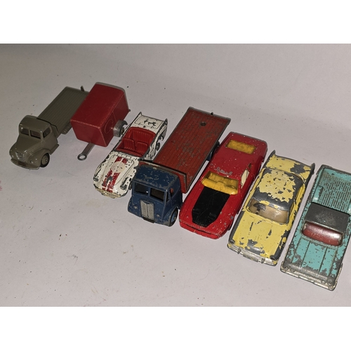 329 - A collection of vintage play worn die cast to include Dinky and Corgi sports cars.