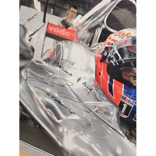 36 - F1 interest: Framed and glazed Jenson Button signed photograph overall size 50x40cm.