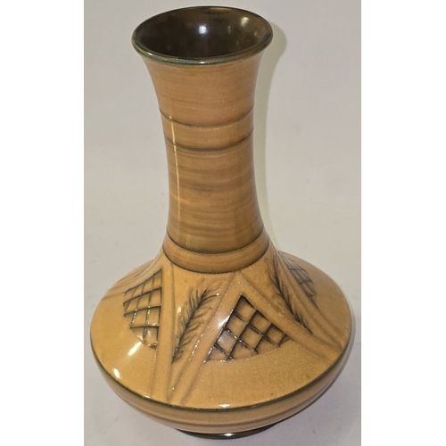 44 - An early Moorcroft Pottery bulbous low waisted vase with flared rim. Unusual pattern possibly a tria... 