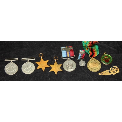 59 - A collection of WWII and later medals including Burma Star, Portuguese Pilot Brevet Wing, Zimbabwean... 
