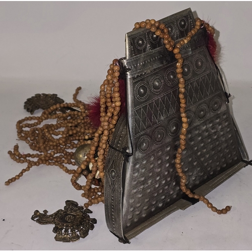 53 - An Asian ladies Akha headdress decorated with metal beads, pendants, red feathers etc.