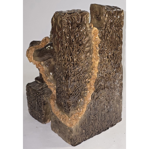 7 - A pottery sculpture depicting a figure bound by rope against a textured background 32cm tall. Firing... 