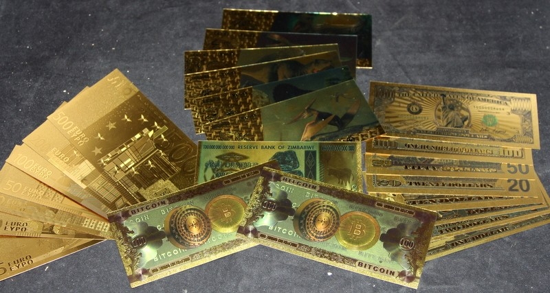 A collection of gold plated bank notes including Euros and US dollars