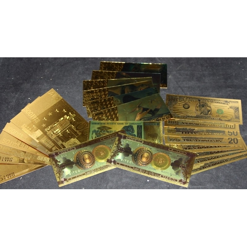 A collection of gold plated bank notes including Euros and US dollars