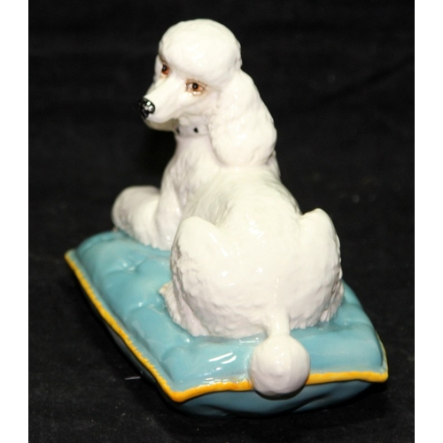 27 - Large Beswick standard poodle sitting on a blue cushion, 18cms across