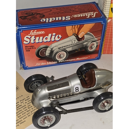 30 - A vintage 1982 clockwork Schuco Studio 1050 Mercedes wind up car boxed together with other items of ... 
