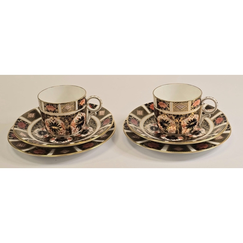221 - Royal Crown Derby: A pair of 1128 Old Imari pattern coffee can trios to include cup, saucer and side... 