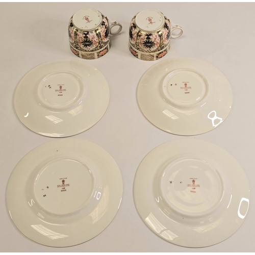 221 - Royal Crown Derby: A pair of 1128 Old Imari pattern coffee can trios to include cup, saucer and side... 