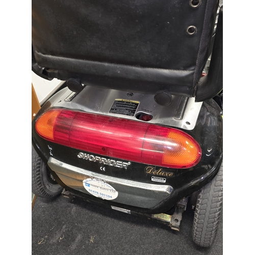 51 - A Shoprider deluxe mobility scooter. Seen recently in working order. Comes with charger and key