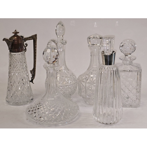 21 - A collection of quality crystal glass decanters to include one with low grade continental silver col... 
