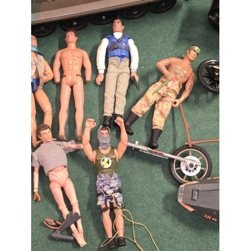 33 - A large collection of Action Man figures, vehicles, clothing and accessories. Includes a couple of e... 