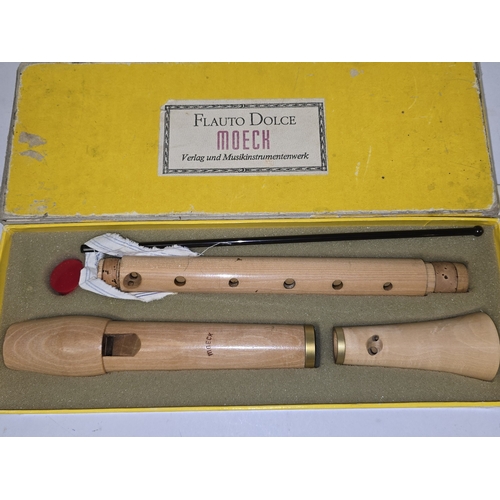 31 - A vintage Flauto Dolce Moeck German wooden recorder together with another smaller recorder. Both app... 