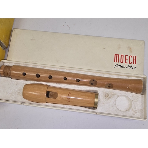 31 - A vintage Flauto Dolce Moeck German wooden recorder together with another smaller recorder. Both app... 