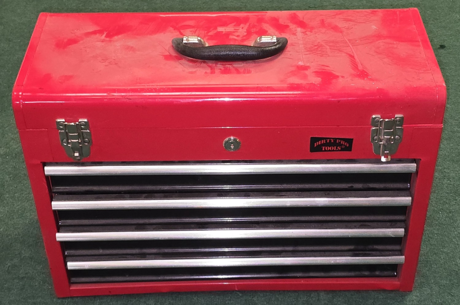 A red lockable tool box fitted with top storage and four drawers ...