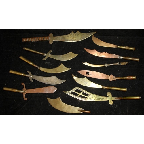 127 - A collection of WWI trench art letter openers, most with bullet grips and inscriptions