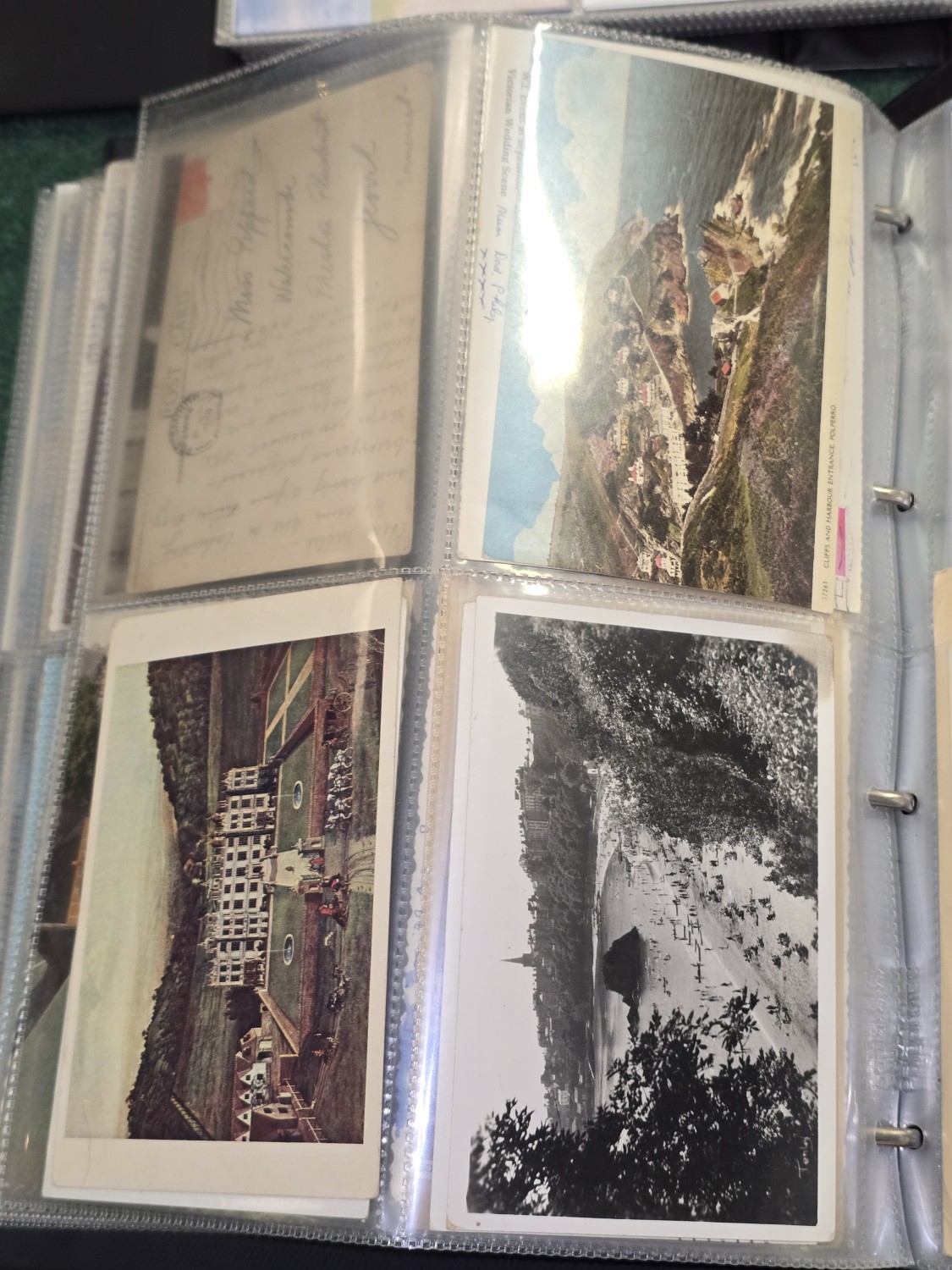A very large collection of postcards in two albums and a box of loose ...