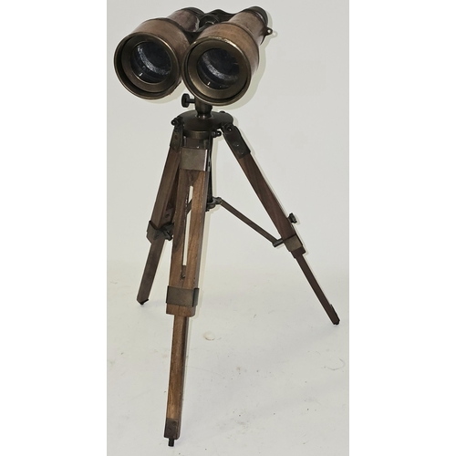 36 - A reproduction nautical style brass binocular telescope on wooden tripod base approx 40cm tall.