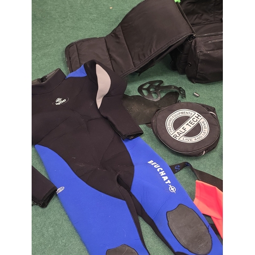 56 - A collection of diving gear to include breathing apparatus and wetsuits.