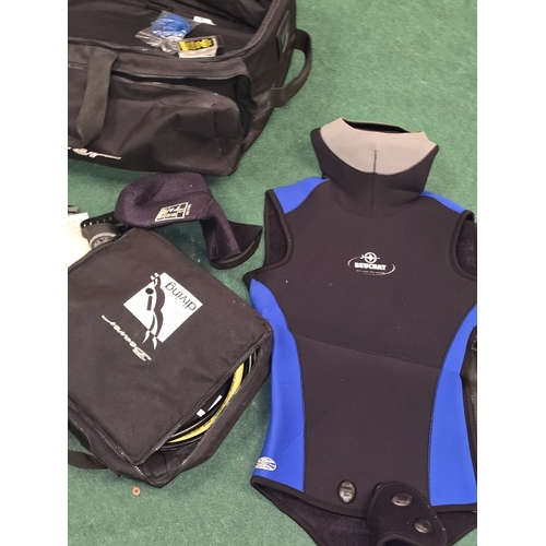 56 - A collection of diving gear to include breathing apparatus and wetsuits.