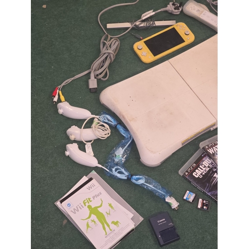 59 - A collection of gaming items to include a Wii console and Xbox 360 console c/w games, leads and acce... 