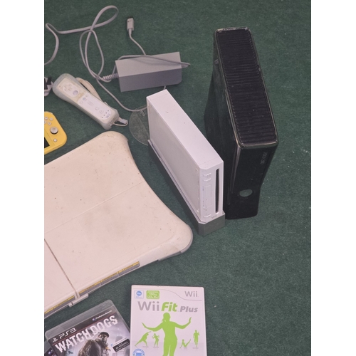 59 - A collection of gaming items to include a Wii console and Xbox 360 console c/w games, leads and acce... 
