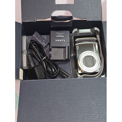 33 - A Panasonic Lumix TZ5 compact digital camera together with a Sony Ericsson Z600 mobile phone.  Both ... 