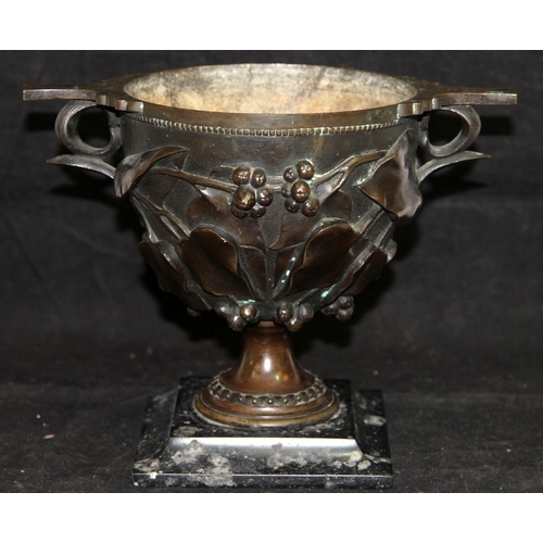 26 - Antique bronze chalice with foliate decoration mounted on a marble plinth. O/all 19cms tall