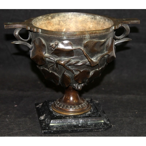 26 - Antique bronze chalice with foliate decoration mounted on a marble plinth. O/all 19cms tall