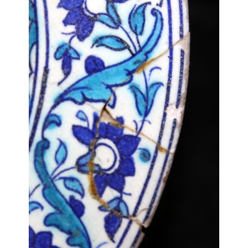 28 - Antique Ottoman Empire Iznik pottery 31cms plate with blue and turquoise decoration. A/f for resrora... 