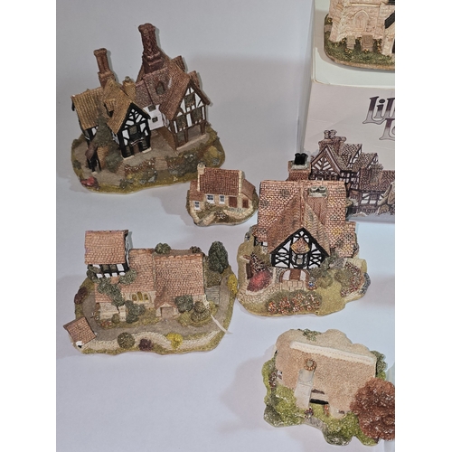 41 - A collection of mostly unboxed Lilliput Lane models to include some paperwork/deeds. Nine models in ... 