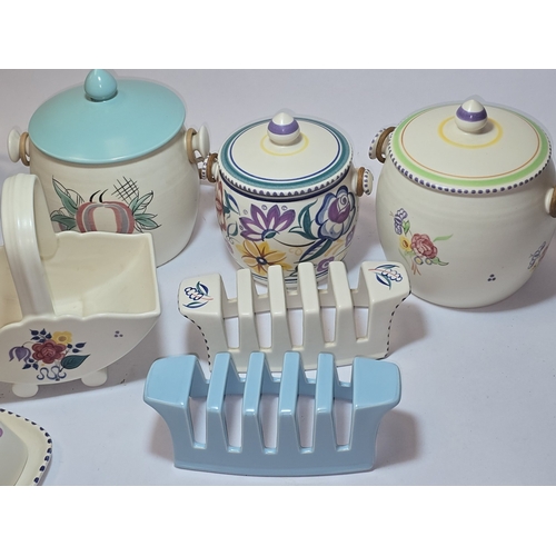 33 - Poole Pottery qty of traditional to include biscuit barrels, toast racks, butter dish etc (9).