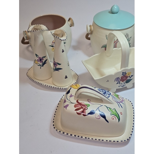 33 - Poole Pottery qty of traditional to include biscuit barrels, toast racks, butter dish etc (9).