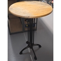 A vintage wooden topped pub table with heavy black painted cast metal ...