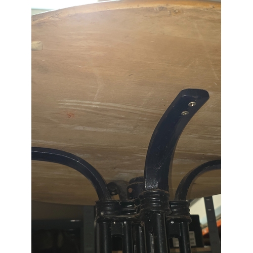 A vintage wooden topped pub table with heavy black painted cast metal ...