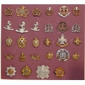 A good carded selection of military cap badges, various eras. 28 in lot