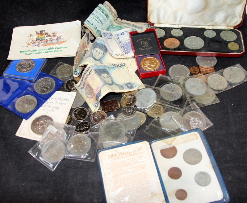 A coin collection mostly consisting of GB Crown coins and foreign banknotes