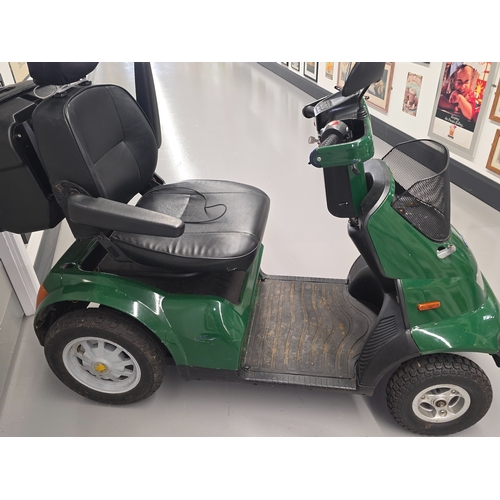 A large green TGA electric mobility scooter. In working order with key ...