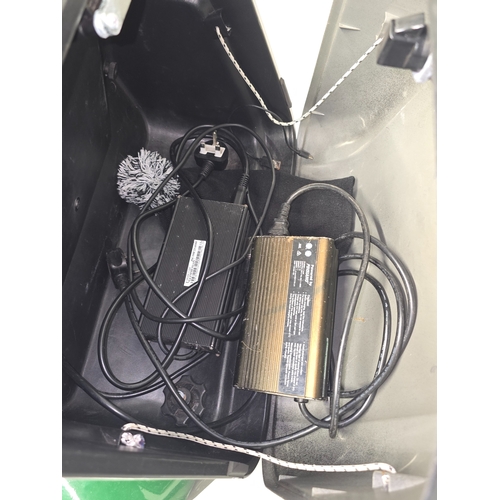 A large green TGA electric mobility scooter. In working order with key ...
