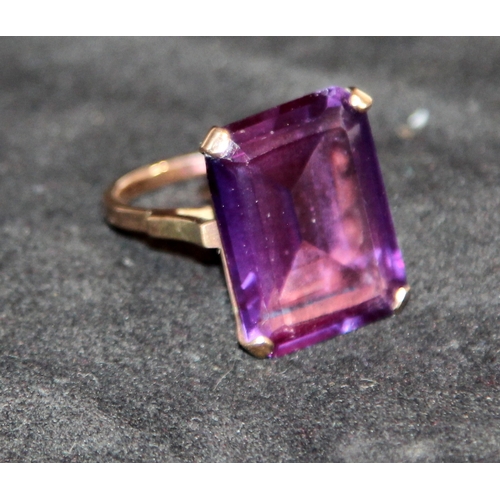 9ct gold dress ring with large emerald cut purple stone. Size N, gross ...