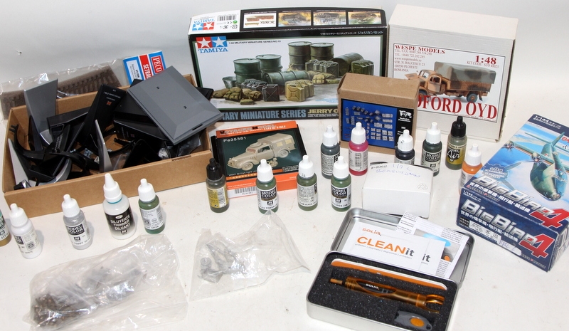A selection of unstarted model kits c/w a selection of paints, glue and ...