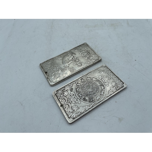 713 - ORIENTAL WHITE METAL SCROLL WEIGHTS