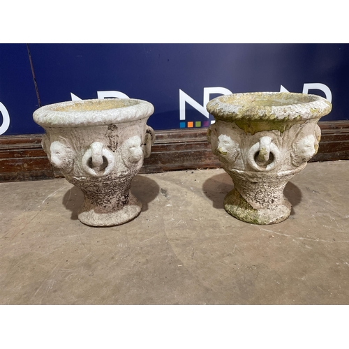 69 - A PAIR OF COMPOSITE STONE URNS